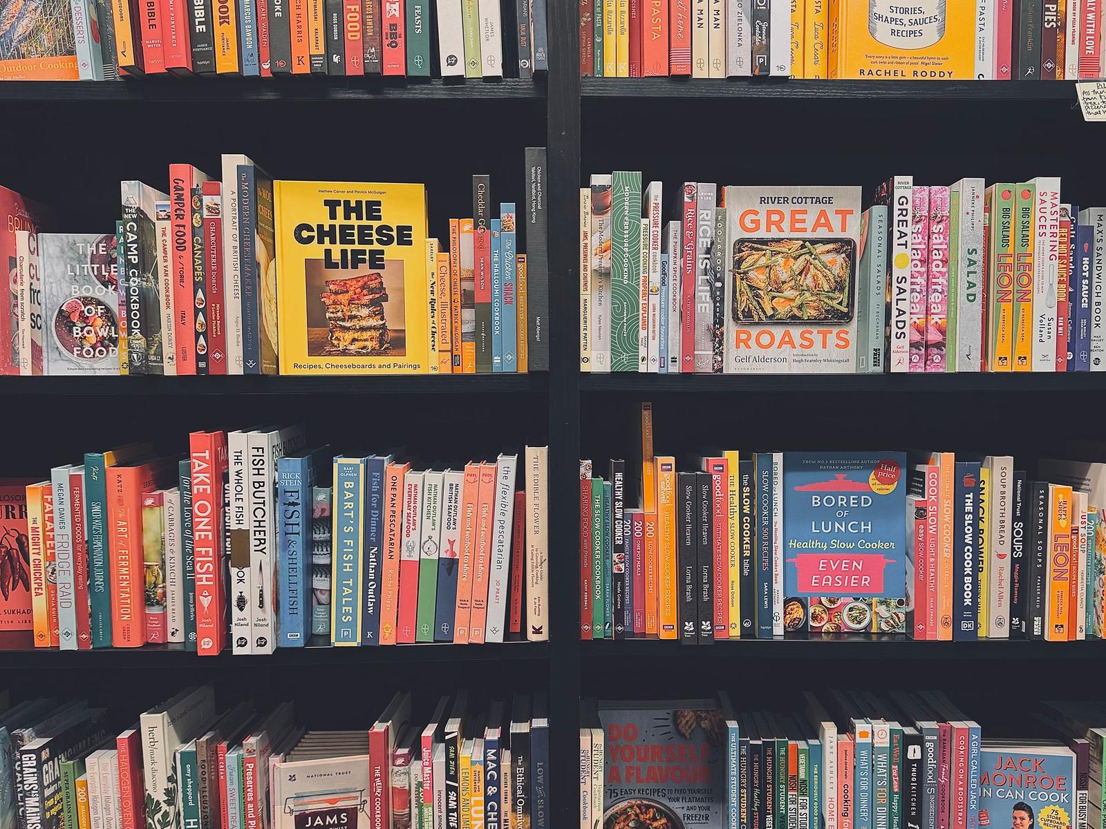 Shelves full of colorful cookbooks