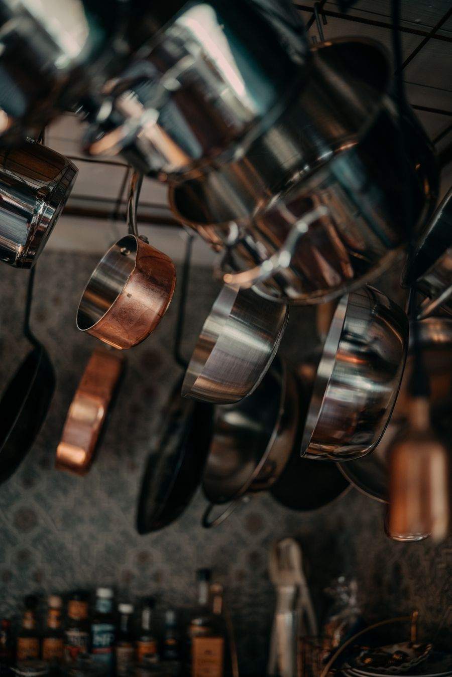 Stainless and copper pans hanging in a kitchen