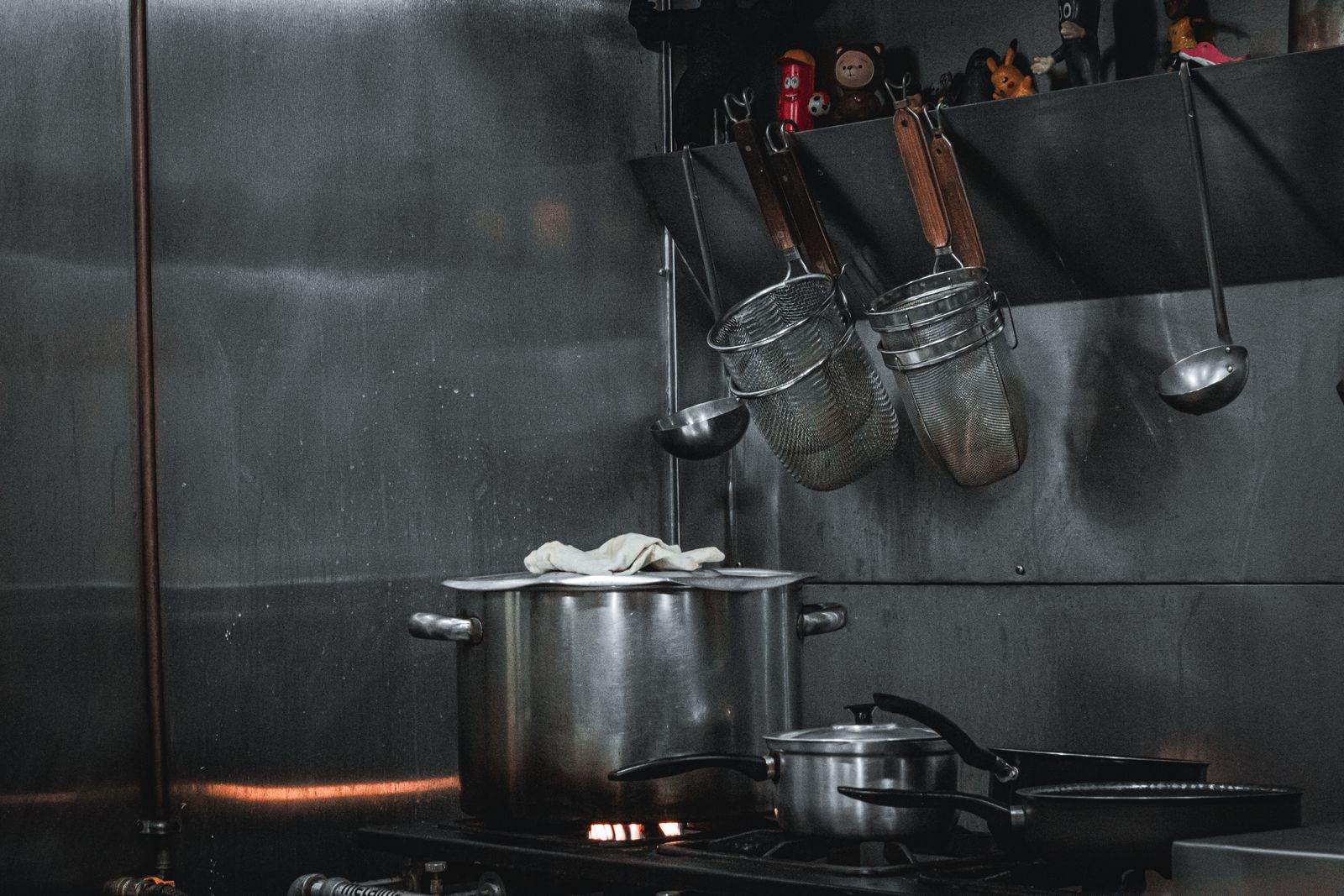 Stainless pots and strainers in a working commercial kitchen
