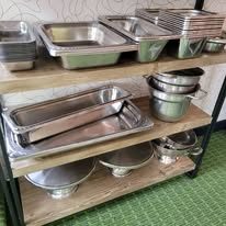 Stainless steam table pans on shelving