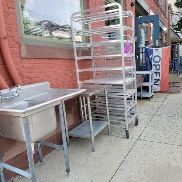 Stainless utility sink and a sheet pan rack